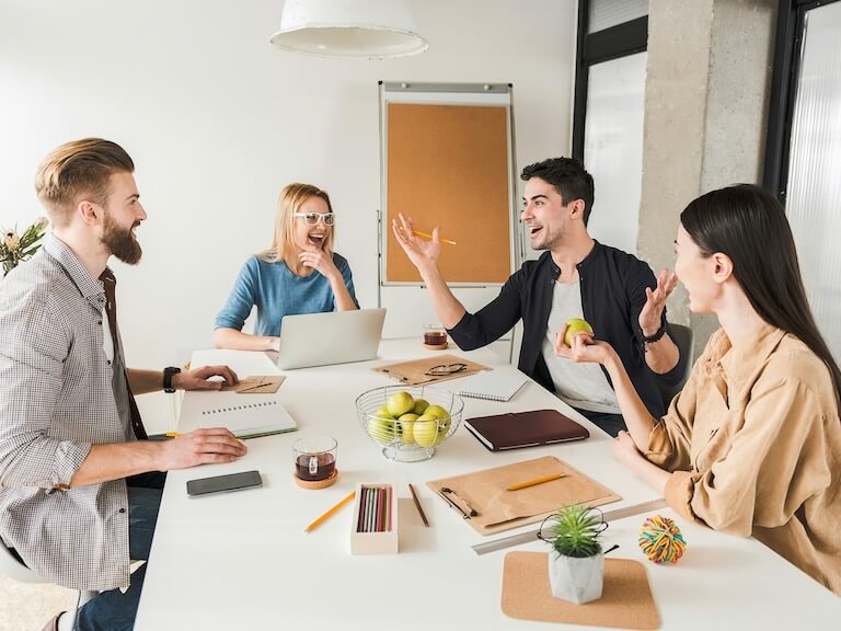 hilarious managers are discussing project they sitting around workplace and listening to their colleague who is jolly
