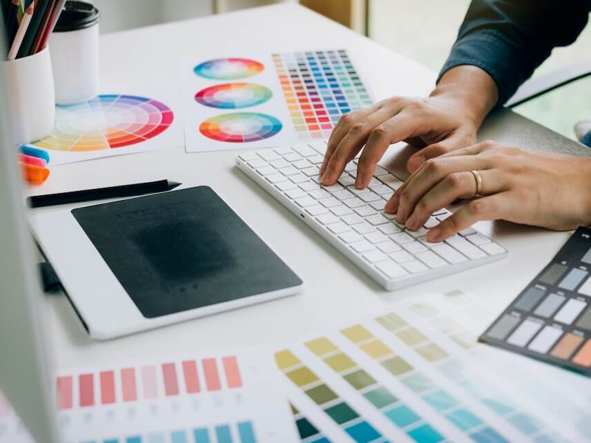 freelance creative designers working on desk in modern home office