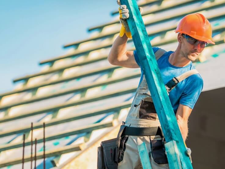 roof construction wood caucasian roofer with wooden building structure element house construction site