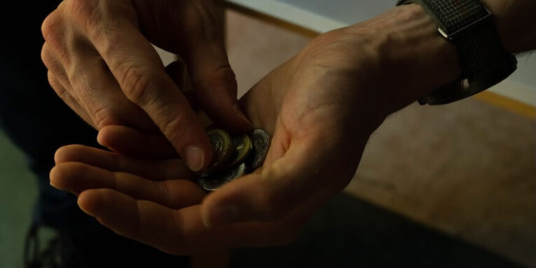 Close-up of hands counting coins, implying budgeting or financial planning FEATURED IMAGE