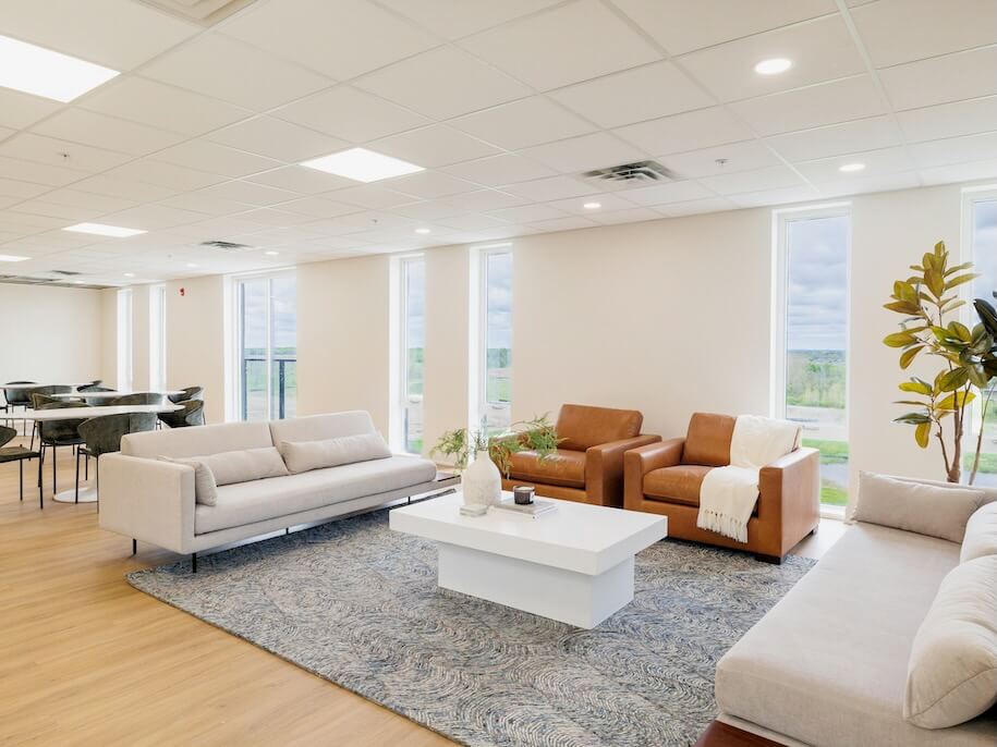 modern office lounge area with seating and tables