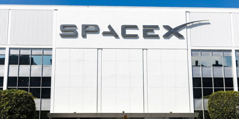 a building with a sign that says spacex on it FEATURED IMAGE