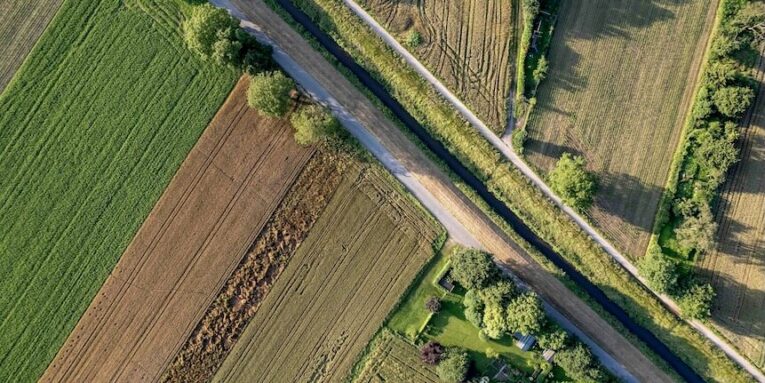 an aerial view of a country road and fields FEATURED GUEST