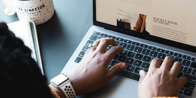 person using MacBook pro on black table FEATURED IMAGE