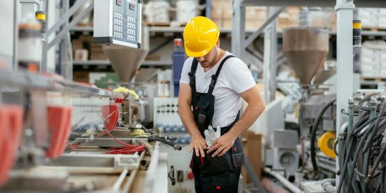 portrait of worker in factory young handsome man working in factory FEATURED IMAGE
