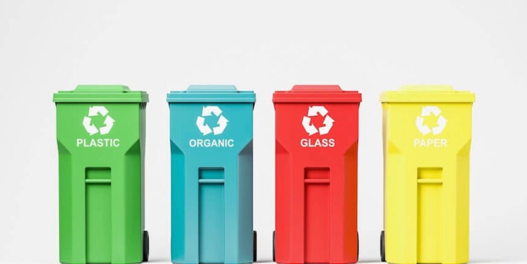 recycling and environmental protection concept row of green blue red and yellow recycle bins over white background FEATURED IMAGE