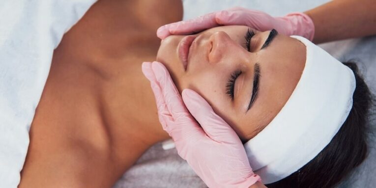 close up view of woman that lying down in spa salon and have face cleaning procedure FEATURED IMAGE