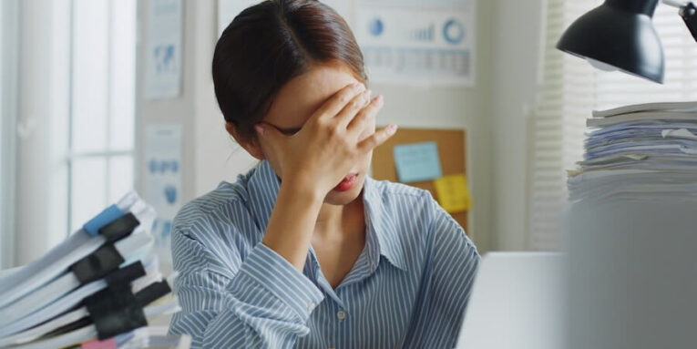 tried young asian office employee feeling sick and have a headache from a long working day at office FEATURED IMAGE