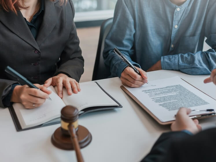 businessman and lawyer sign the contract the agreement in the document