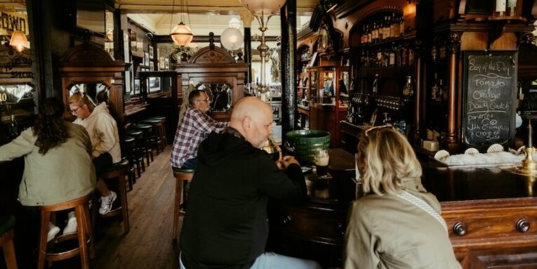 people enjoying drinks in a traditional pub interior