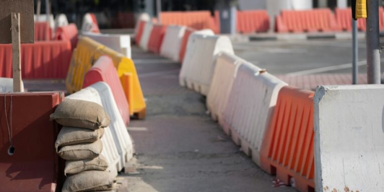 a row of orange and white barriers sitting next to each other FEATURED IMAGE