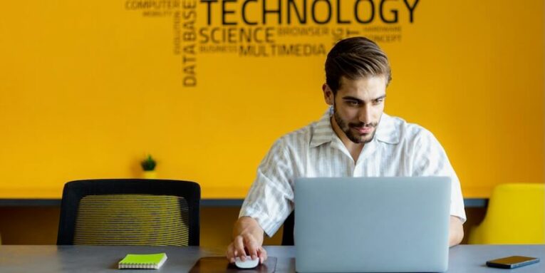 a man sitting in front of a laptop computer FEATURED IMAGE
