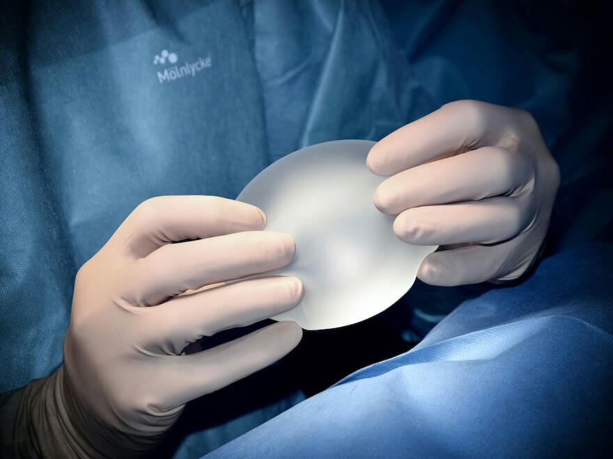person holding white heart shaped ornament