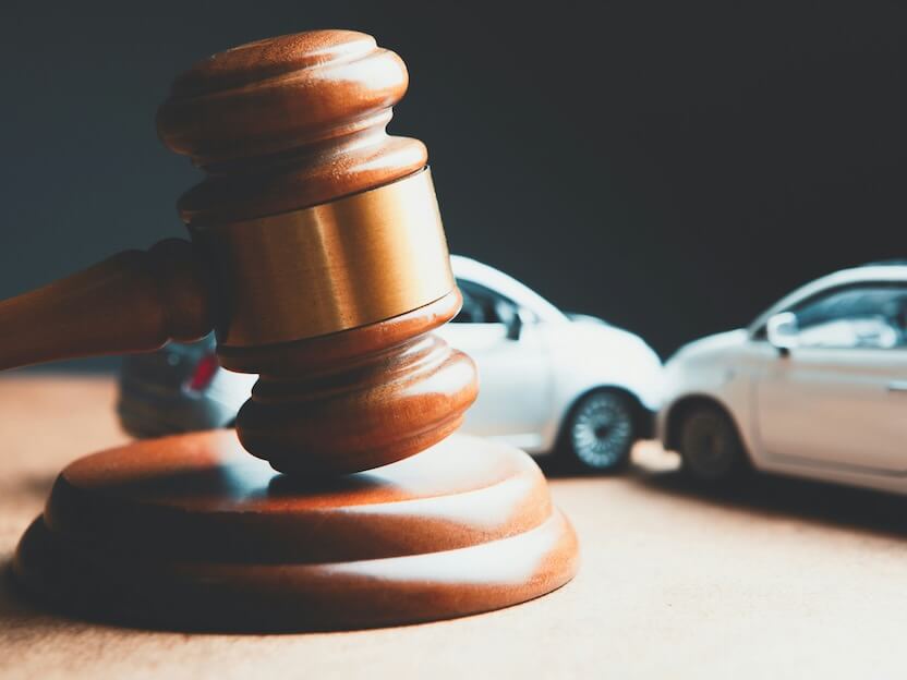 a toy car and a wooden gaven on a table