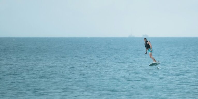a person riding a hydrofoil board on the ocean FEATURED IMAGE