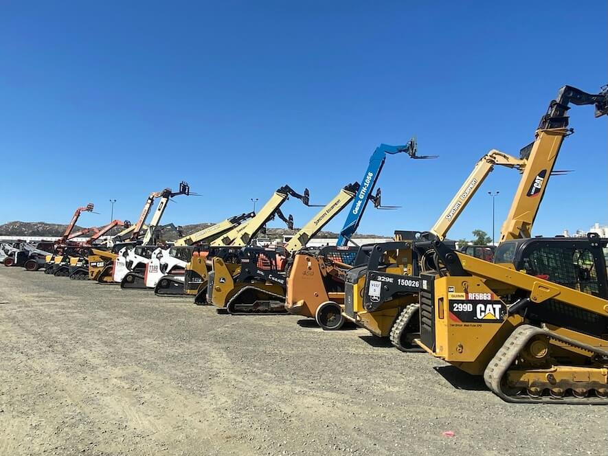 a group of yellow and black construction vehicles