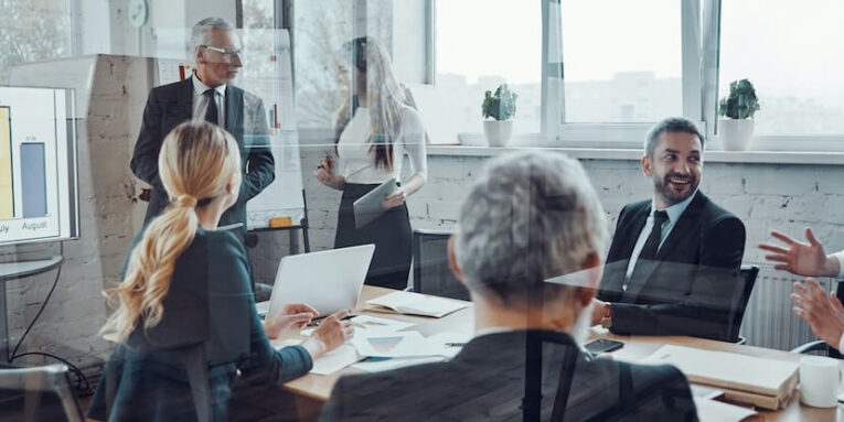 confident businessman conducting a presentation while having staff meeting in the board room FEATURED IMAGE