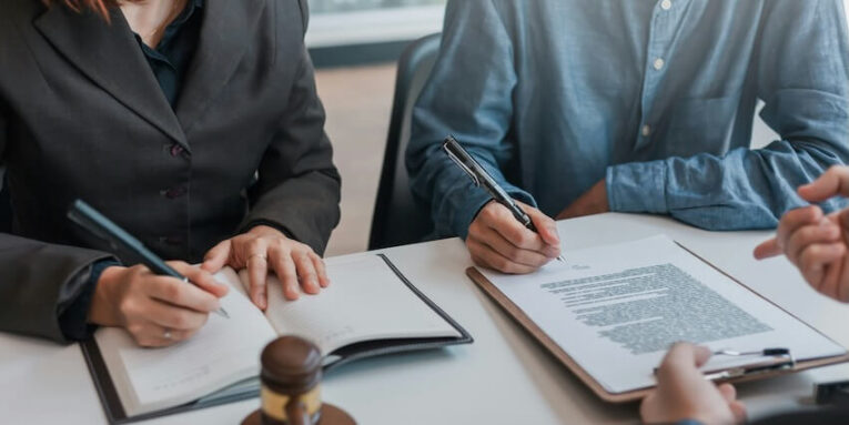 businessman and lawyer sign the contract the agreement in the document FEATURED IMAGE