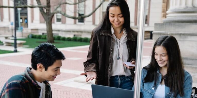 Group of university students collaborating and studying together in an outdoor setting FEATURED IMAGE
