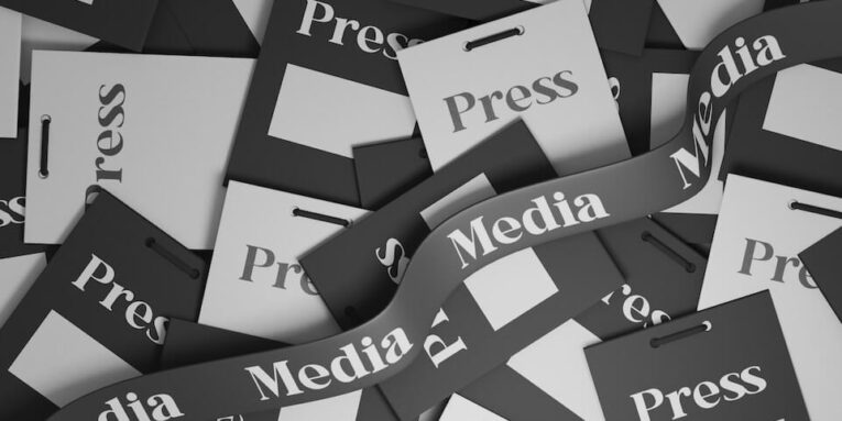 a pile of black and white papers with the word press on them FEATURED IMAGE