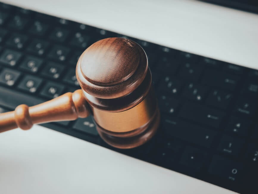 a wooden gaven sitting on top of a computer keyboard