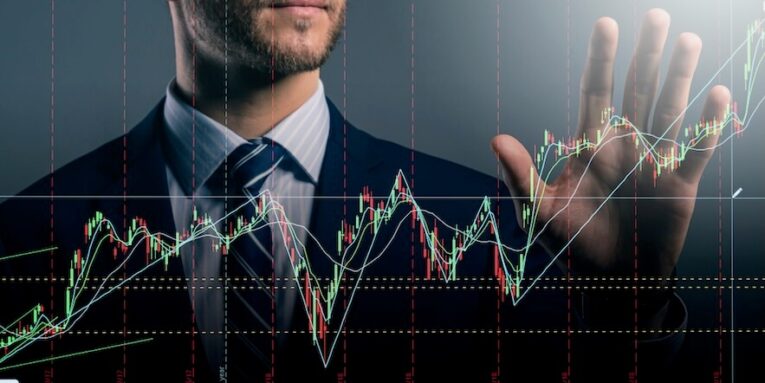 smart caucasian businessman hand touch invisible stock chart market screen dark background business financial ideas concept FEATURED IMAGE