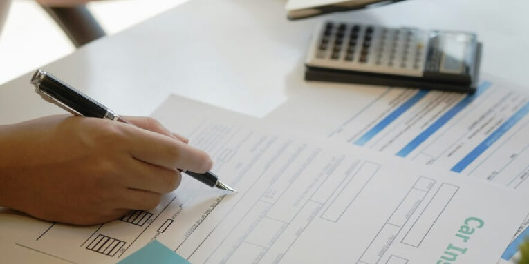 Someone signs insurance policy FEATURED IMAGE