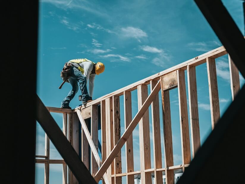 construction worker in hard hat on building frame