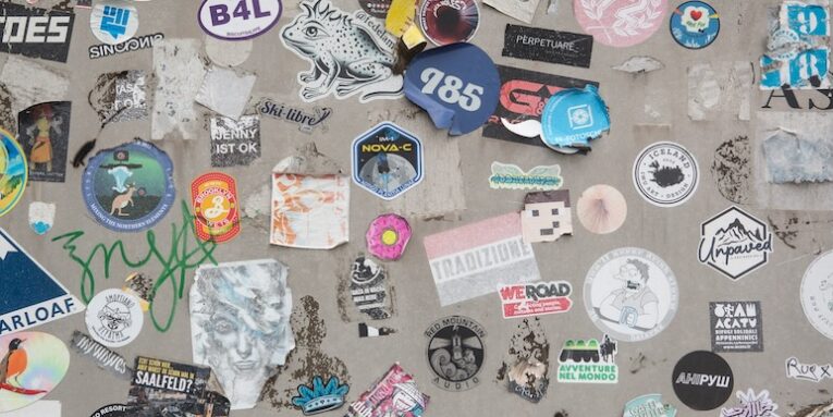 a wall covered in lots of different types of stickers FEATURED IMAGE