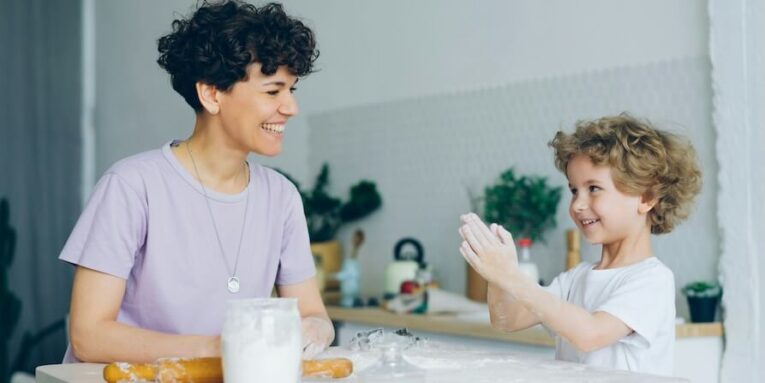 a woman and a child are sitting at a table FEATURED IMAGE