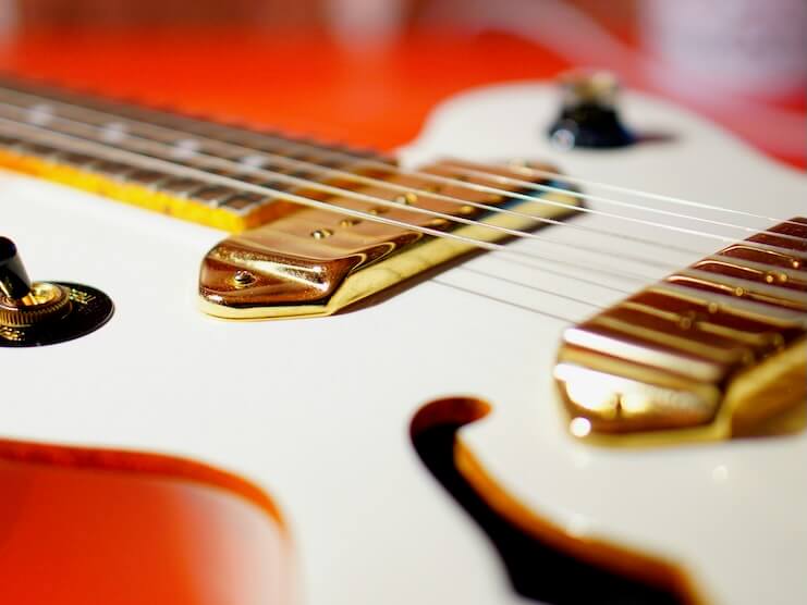 white and red electric guitar